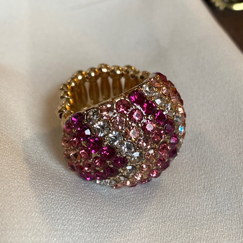Gold tone ring with pink and clear rhinestones